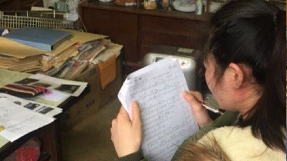 酪農会社で基礎級試験の問題を確認している実習生